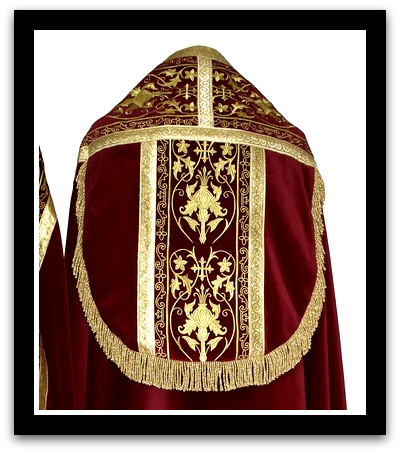 Spanish style Roman cope in deep red velvet material with ornate embroidery.